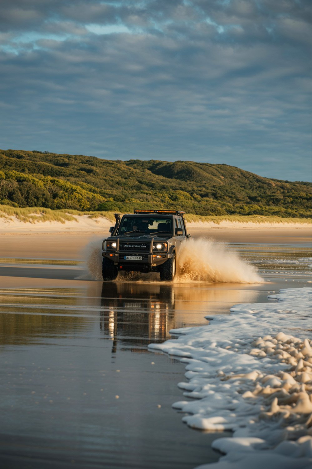 75 Mile Beach on Fraser Island with 4WD vehicle driving along the sandy shoreline