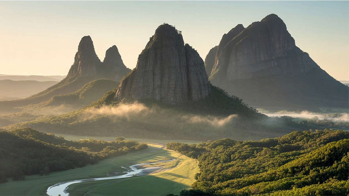 Explore the scenic hiking trails of Glass House Mountains, offering stunning views and natural beauty, as featured on Pathfinders Travel.