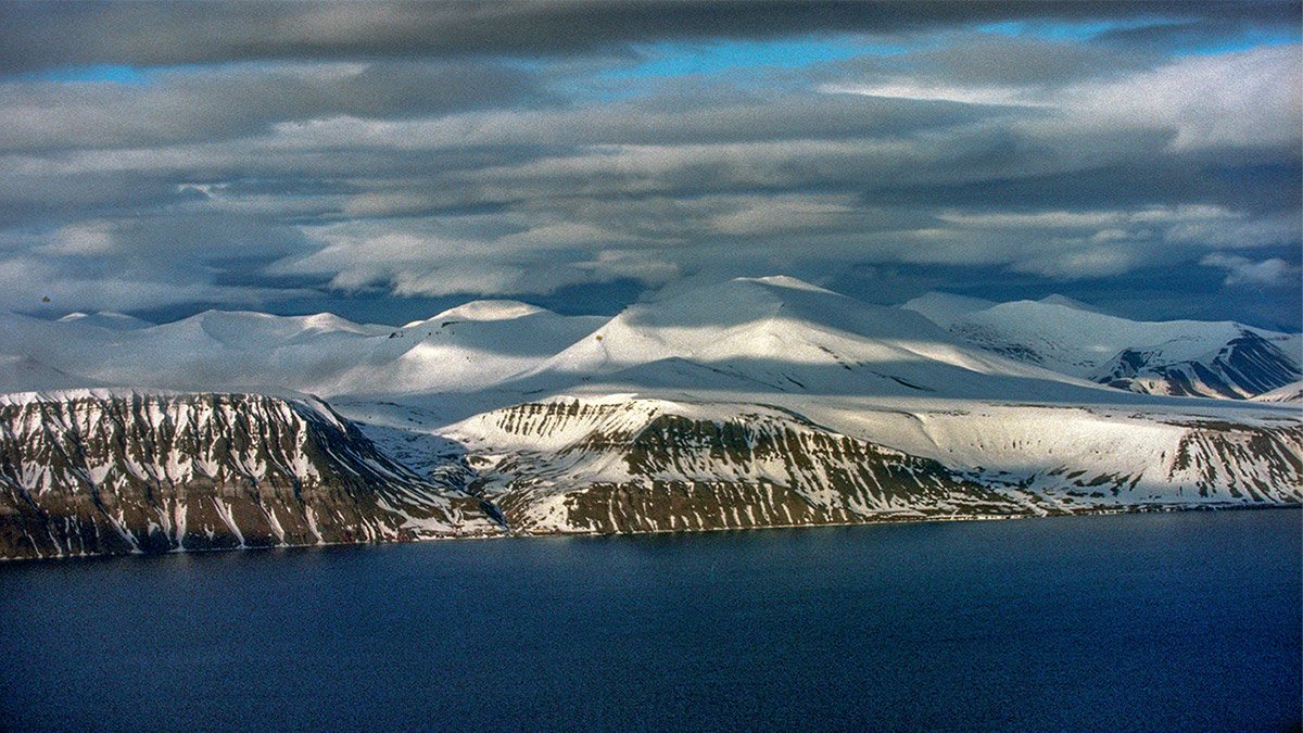 Isfjorden Glacier Calving in Svalbard, featuring a breathtaking view of the glacier's dramatic ice breakup in the Arctic, captured by Pathfinders Travel