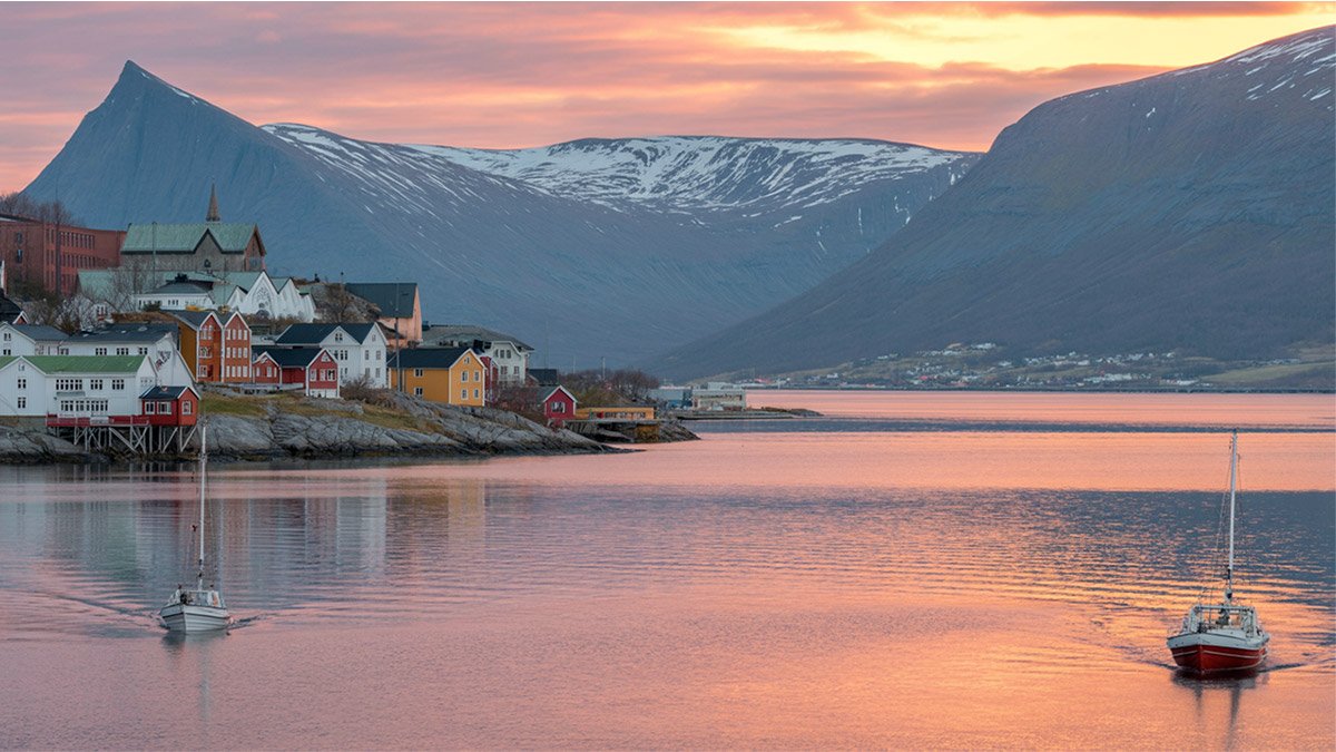 Midnight sun over Tromsø in Northern Norway with mountains and sea view