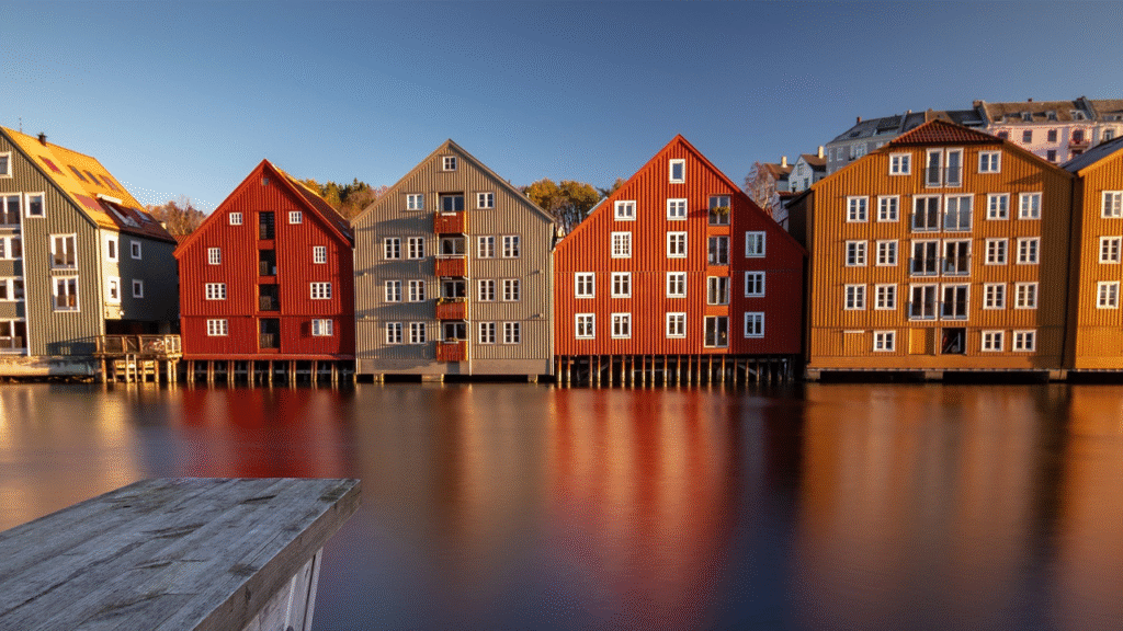 Colorful wooden buildings reflected in the water in one of the best cities in Norway to visit