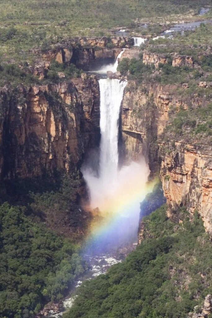 Jim Jim Falls waterfall plunging into a deep pool surrounded by sandstone cliffs in Kakadu National Park, Australia