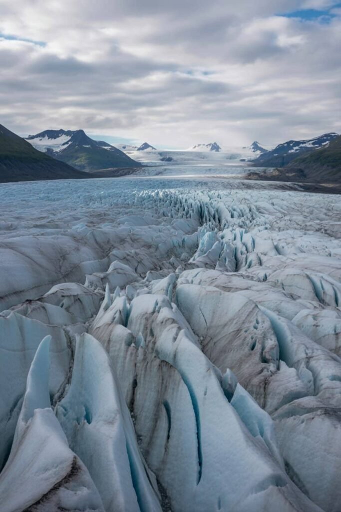 Expansive view of the Harding Icefield in Kenai Fjords National Park, Alaska, showcasing glacier formations and rugged mountain terrain — a highlight of the Harding Icefield Trail hike featured in the Pathfinders Travel guide.