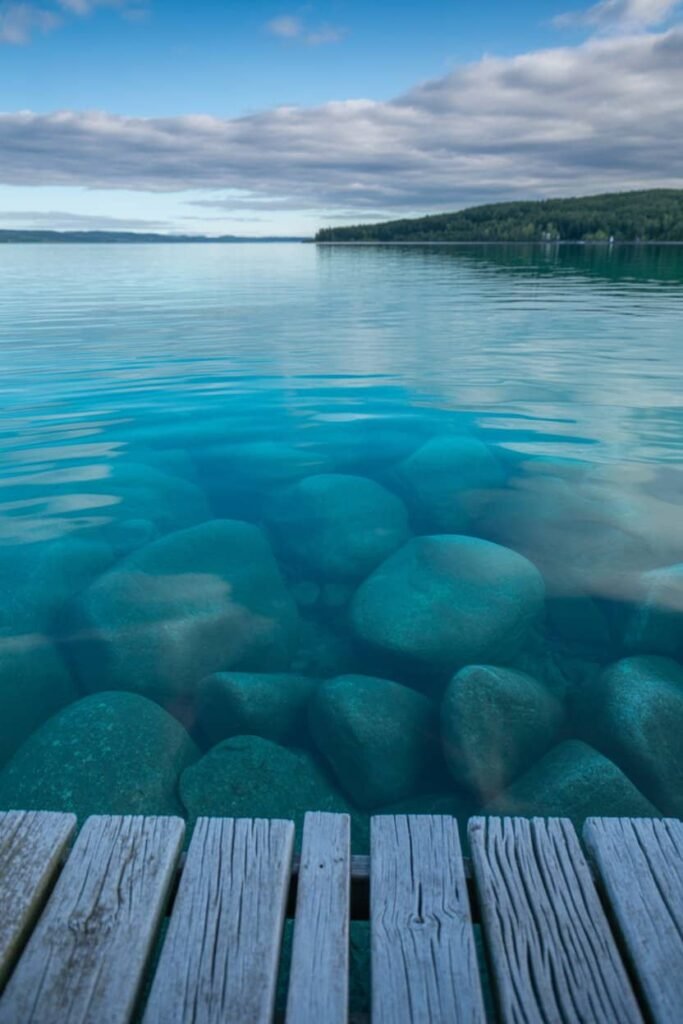 Crystal-clear turquoise water at Little Tub Harbour in Tobermory, Ontario, reflecting boats and limestone cliffs under bright summer skies, captured for Pathfinders Travel.