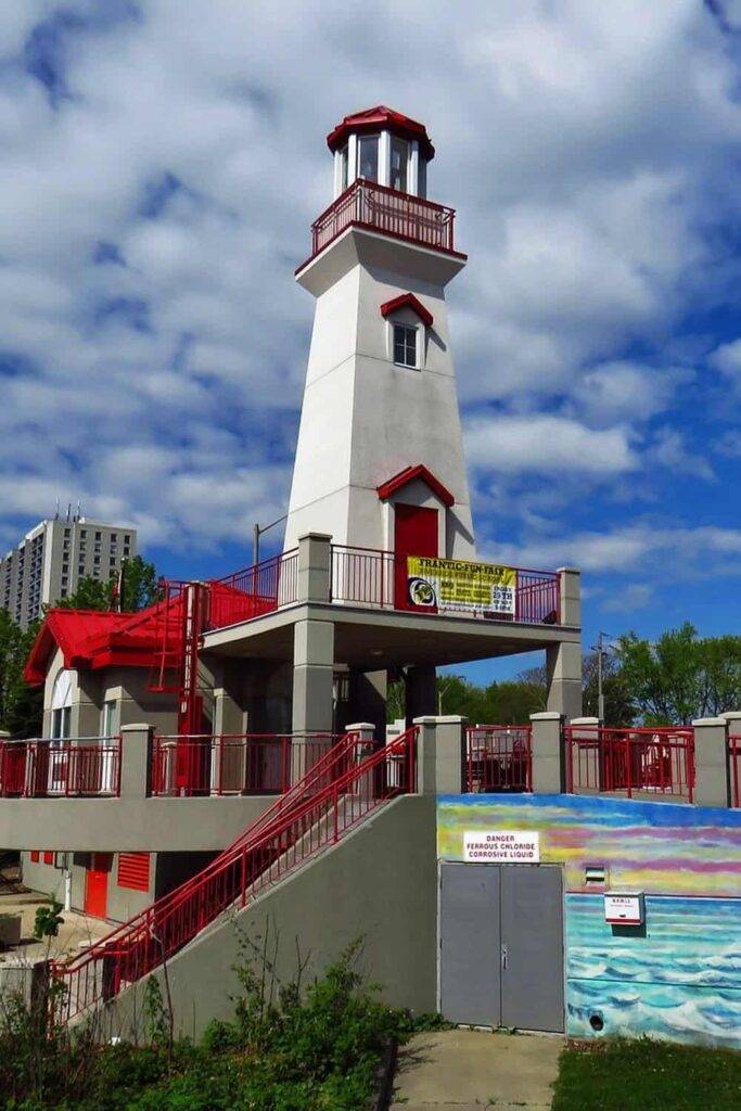 Port Credit Lighthouse Mississauga waterfront with boats and boardwalk views featured in Pathfinders Travel’s Oakville Ontario day trip guide.