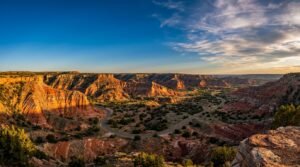 Panoramic view of Palo Duro Canyon's colorful layered rock formations at sunset in Texas