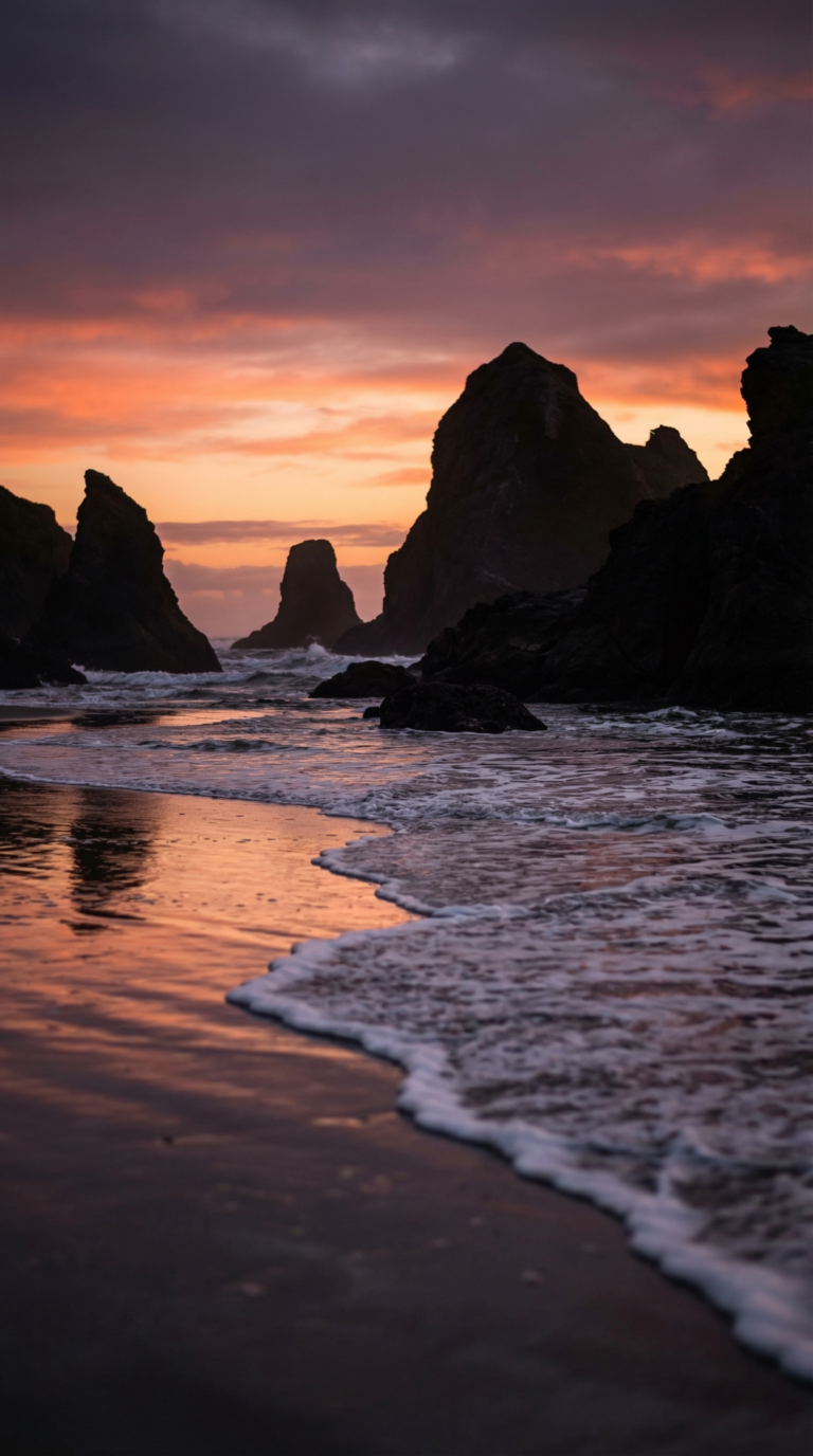 Bandon Beach Oregon at sunset with sea stacks and Face Rock silhouettes