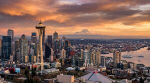 Seattle skyline featuring Space Needle with Mount Rainier in background at golden hour