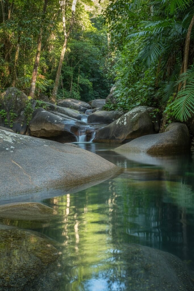 Mossman Gorge crystal-clear stream flowing over granite boulders in tropical rainforest near Cairns