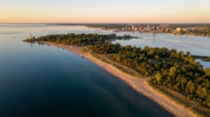 Aerial view of Presque Isle State Park peninsula extending into Lake Erie at sunset in Erie, Pennsylvania