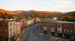 Historic Victorian buildings along Broadway Street in Jim Thorpe, Pennsylvania with autumn mountain backdrop