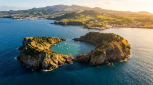Aerial view of Vila Franca Islet volcanic crater with turquoise lagoon in the Azores