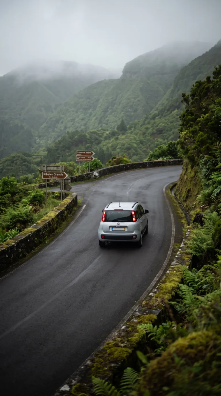 Scenic mountain road leading to Caldeira Velha hot springs in São Miguel Azores with thick vegetation