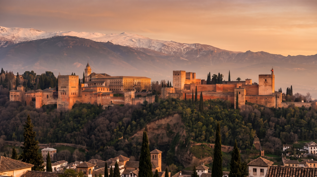 The Alhambra palace in Granada Spain at golden hour with the Sierra Nevada mountains behind